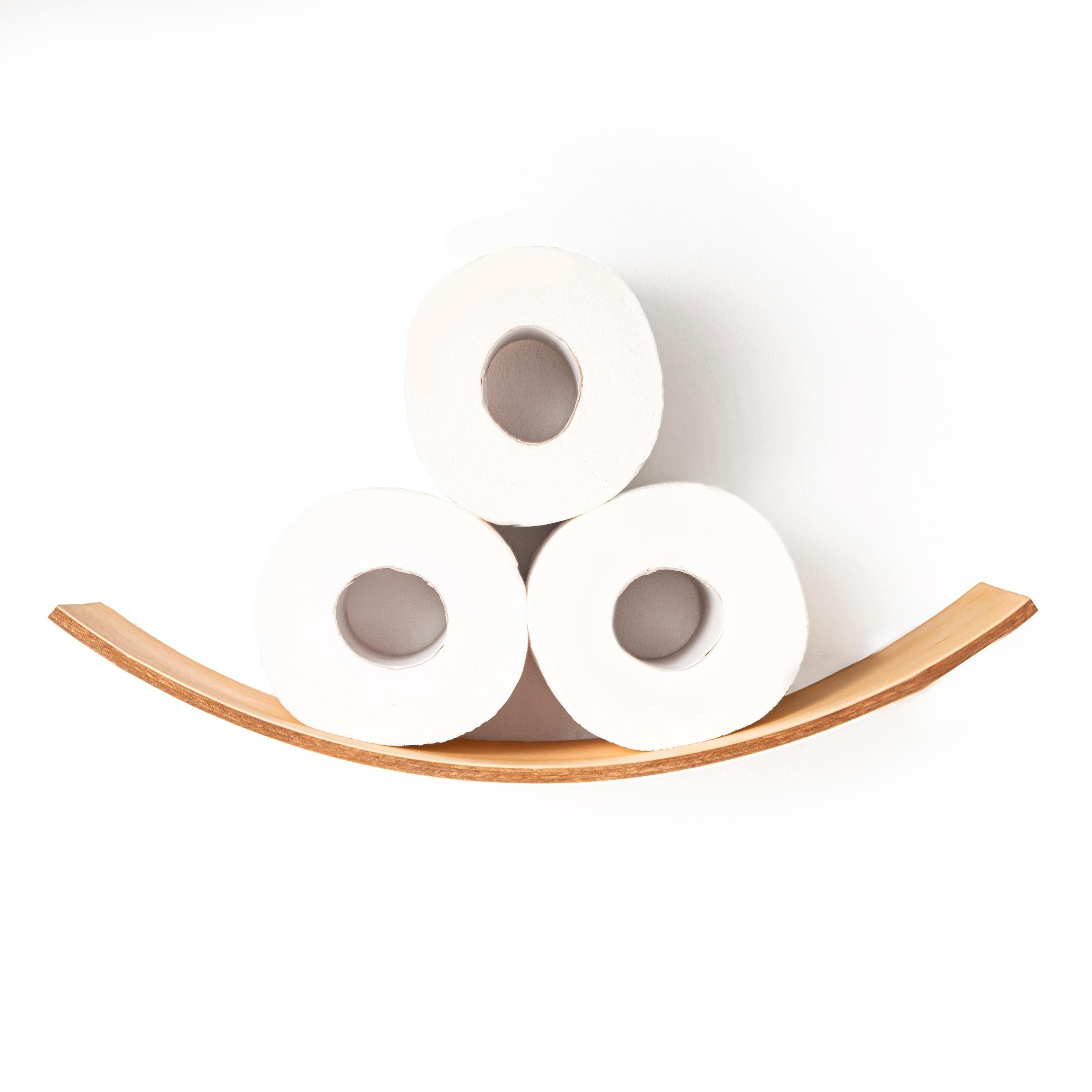 Close-up of a curved wooden toilet paper holder with three toilet paper rolls neatly stacked. The holder features a smooth, natural wood finish, designed for a minimalist and functional display.
